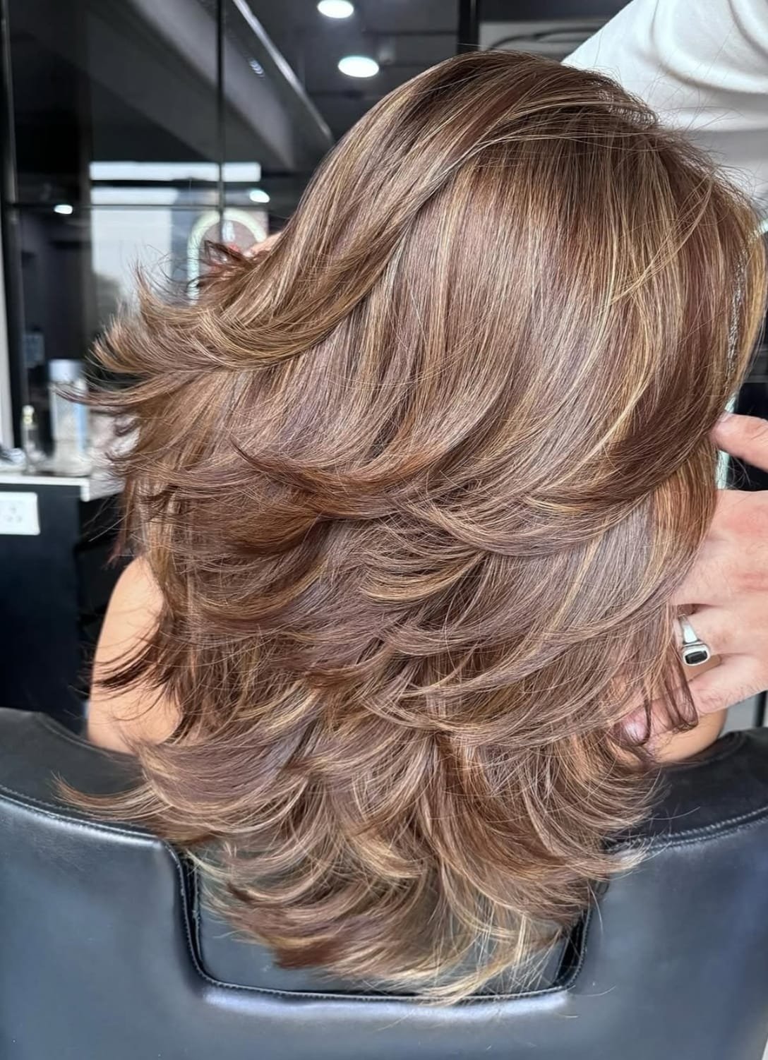 Layered hair finish with soft movement through the lengths.